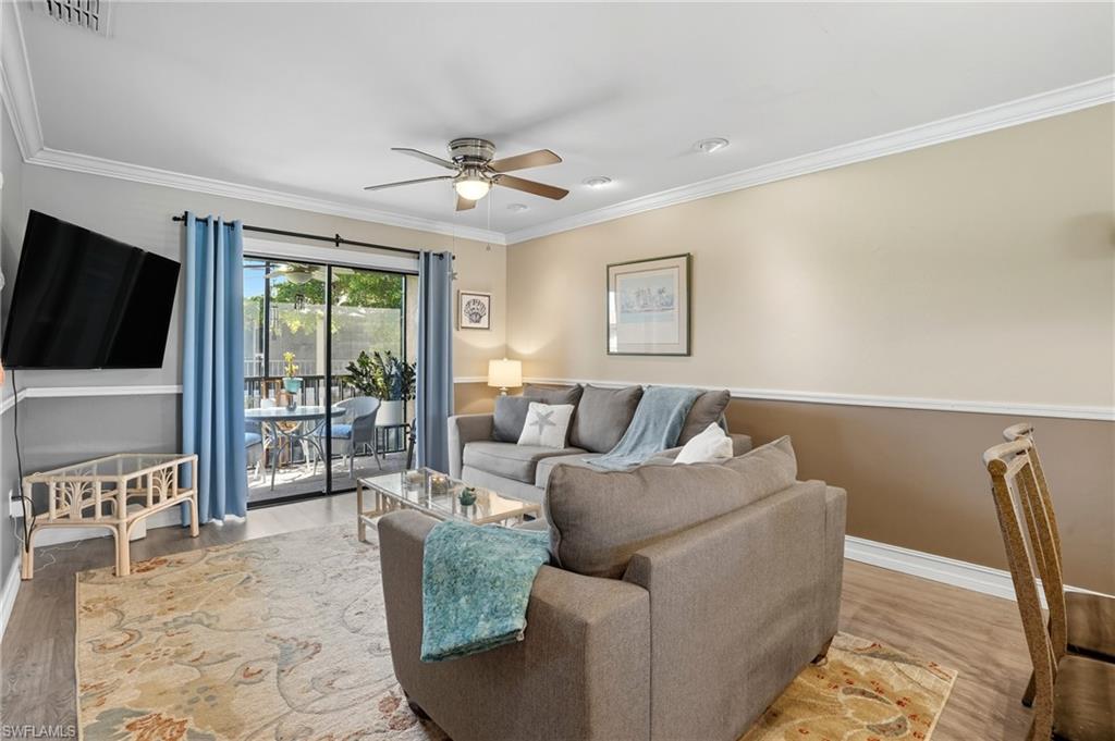 4790 South Cleveland Avenue, Unit 907 Fort Myers, FL 33907 - Photo 6 of 24 Living area with ornamental molding, sliders to balcony, and ceiling fan