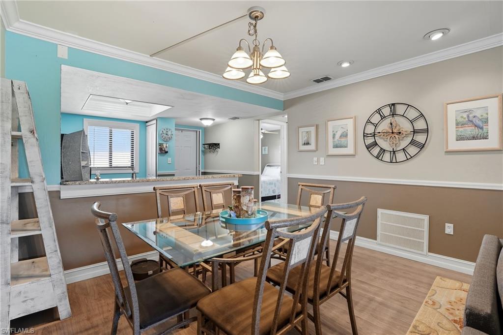 4790 South Cleveland Avenue, Unit 907 Fort Myers, FL 33907 - Photo 7 of 24 Dining space with ornamental molding, and a chandelier