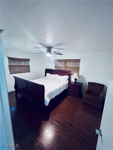 a bedroom with furniture and wooden floor