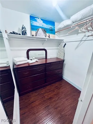 a bed sitting in a bedroom next to a larger window