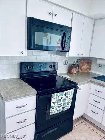 a kitchen with stainless steel appliances granite countertop a stove and a microwave