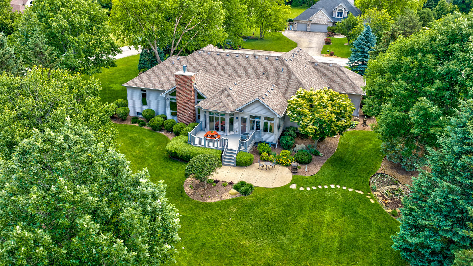10907 Red Hawk Lane Spring Grove, IL 60071 - Photo 37 of 44 a view of a house with garden and a swimming pool