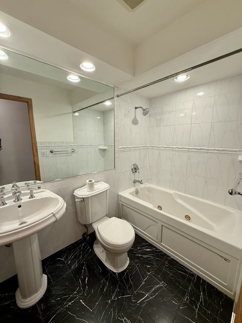 414 South Dee Road Park Ridge, IL 60068 - Photo 22 of 37 a bathroom with a sink toilet and shower