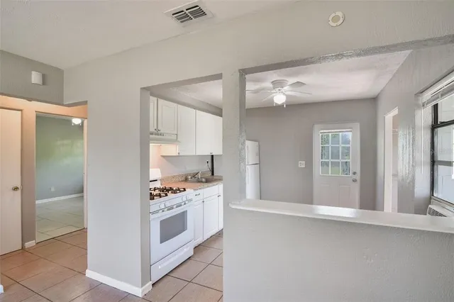 a kitchen with stainless steel appliances a stove a sink and a refrigerator