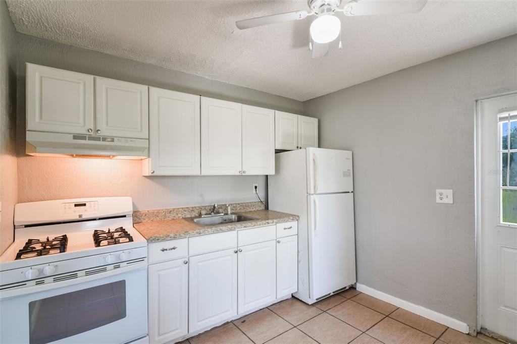 1220 Morin Street, Unit A Eustis, FL 32726 - Photo 8 of 20 a kitchen with cabinets appliances and a counter space