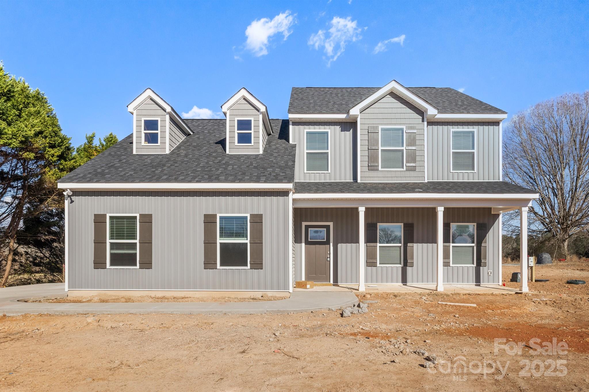 a front view of a house with a yard and parking space