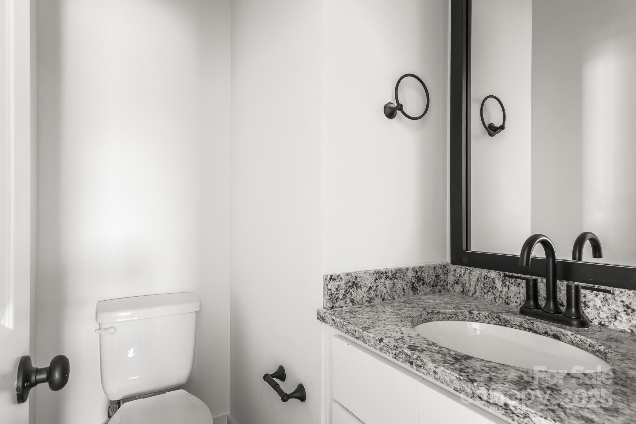 3303 Old Pageland Monroe Road Monroe, NC 28112 - Photo 13 of 37 a bathroom with a granite countertop sink and a mirror