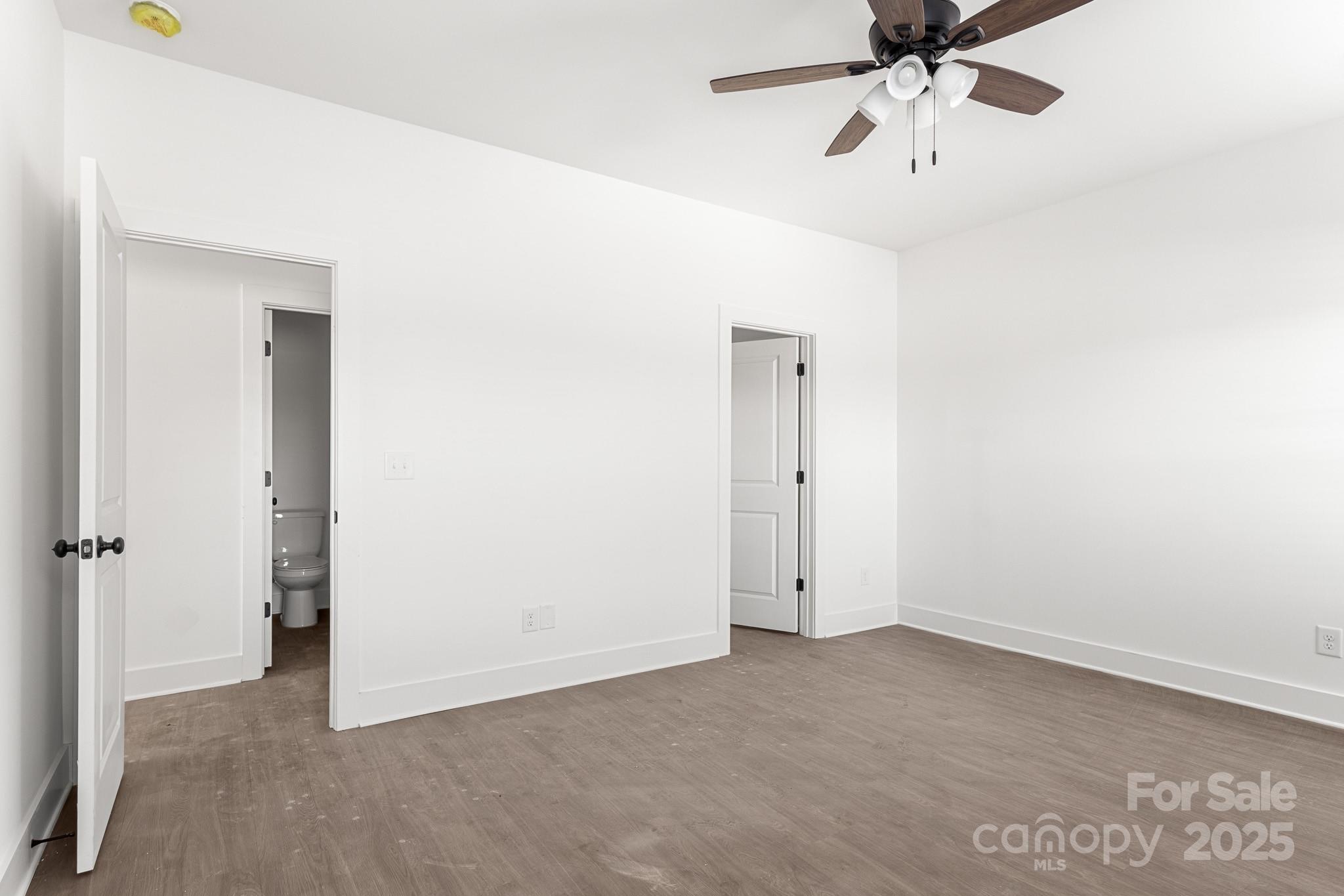3303 Old Pageland Monroe Road Monroe, NC 28112 - Photo 15 of 37 an empty room with a ceiling fan and carpet
