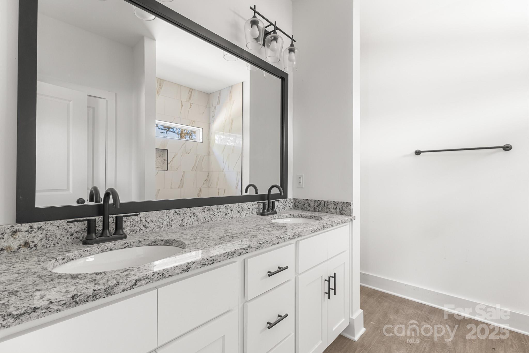 3303 Old Pageland Monroe Road Monroe, NC 28112 - Photo 17 of 37 a bathroom with a granite countertop sink and a mirror
