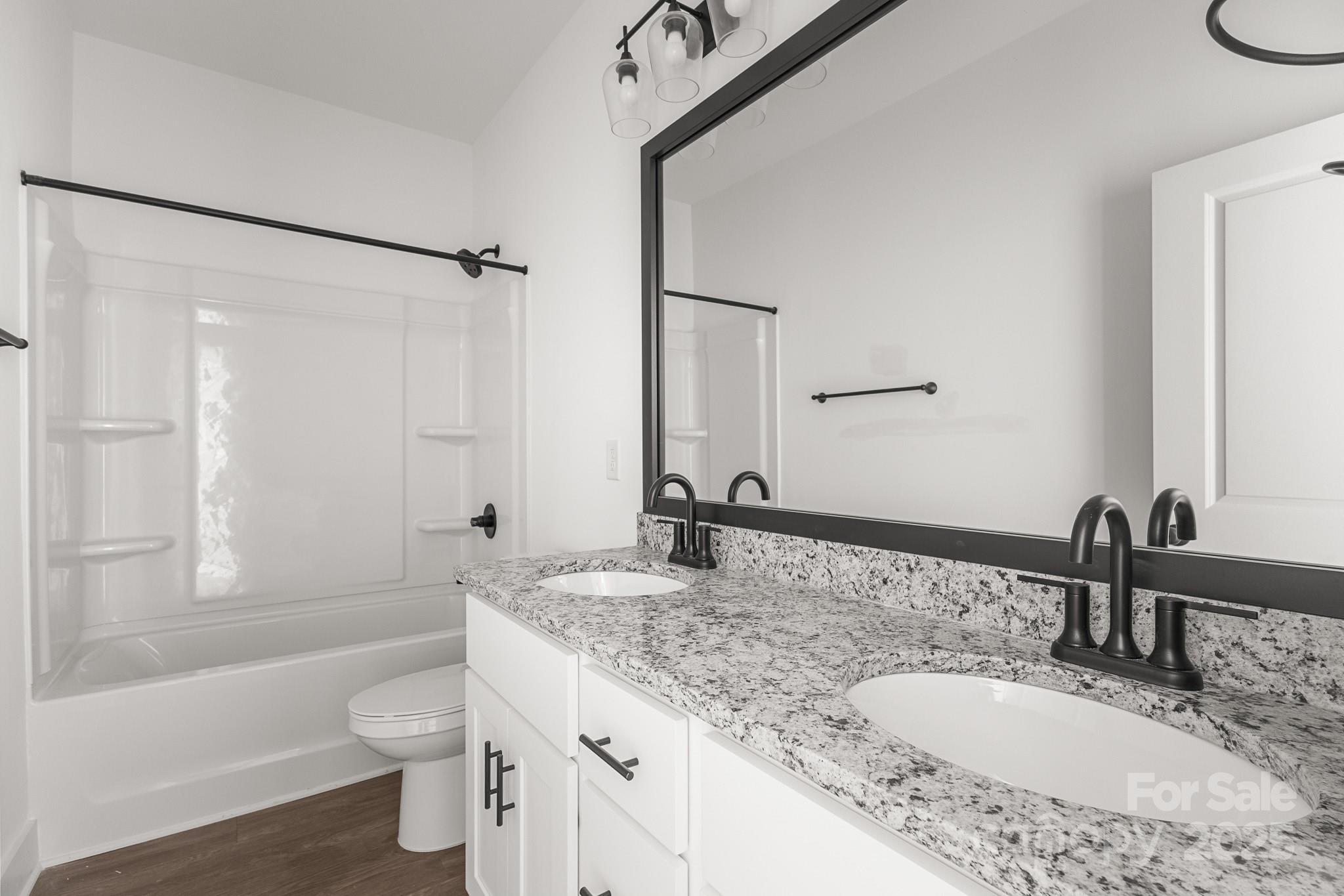 3303 Old Pageland Monroe Road Monroe, NC 28112 - Photo 26 of 37 a bathroom with a granite countertop sink toilet and shower