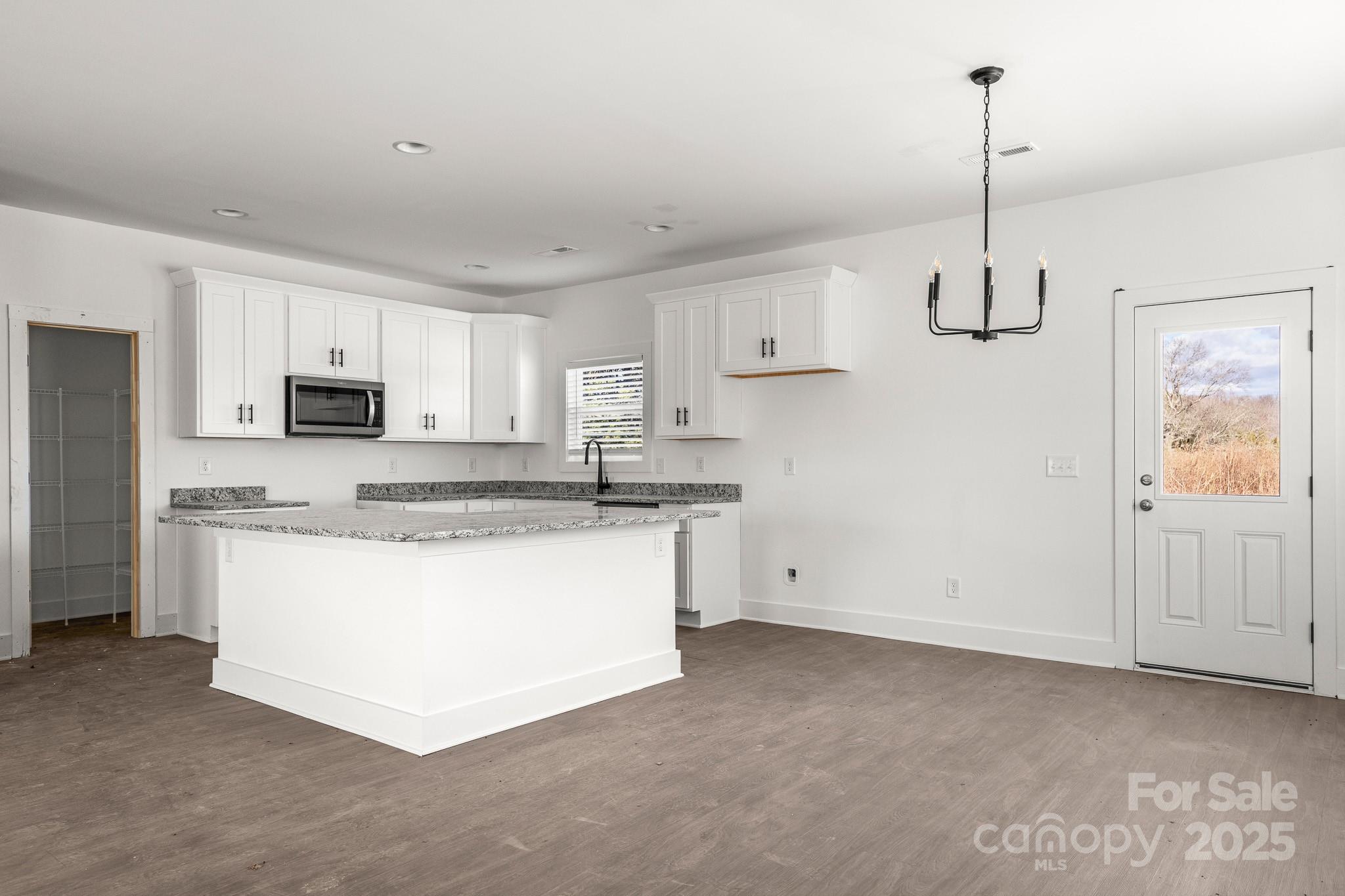 3303 Old Pageland Monroe Road Monroe, NC 28112 - Photo 7 of 37 a kitchen with stainless steel appliances granite countertop white cabinets and window