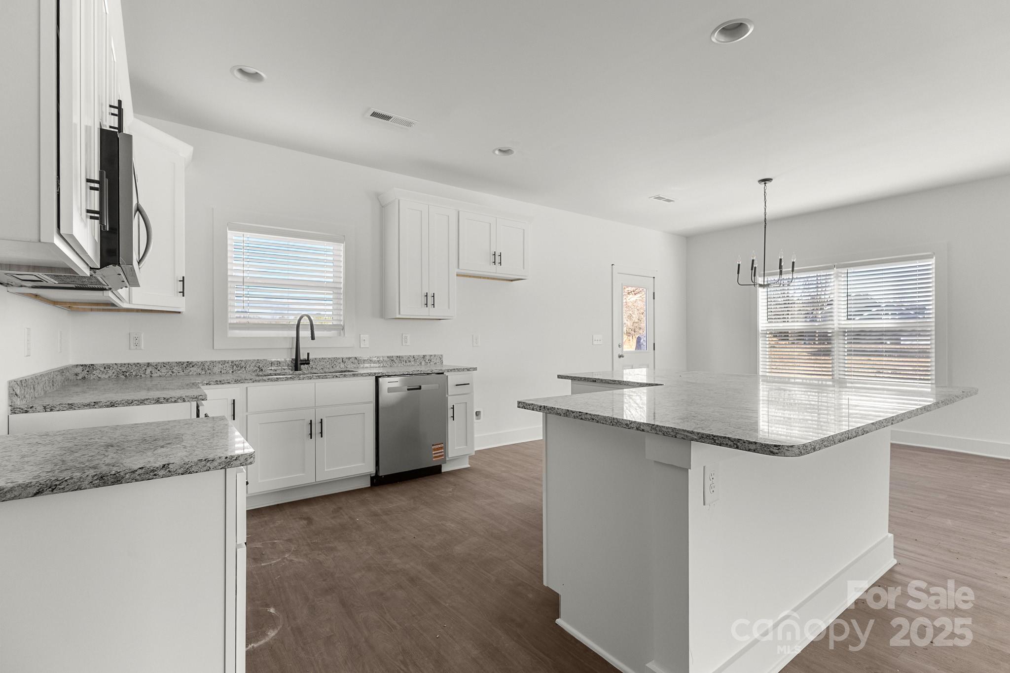 3303 Old Pageland Monroe Road Monroe, NC 28112 - Photo 10 of 37 a kitchen with stainless steel appliances granite countertop a sink stove and cabinets