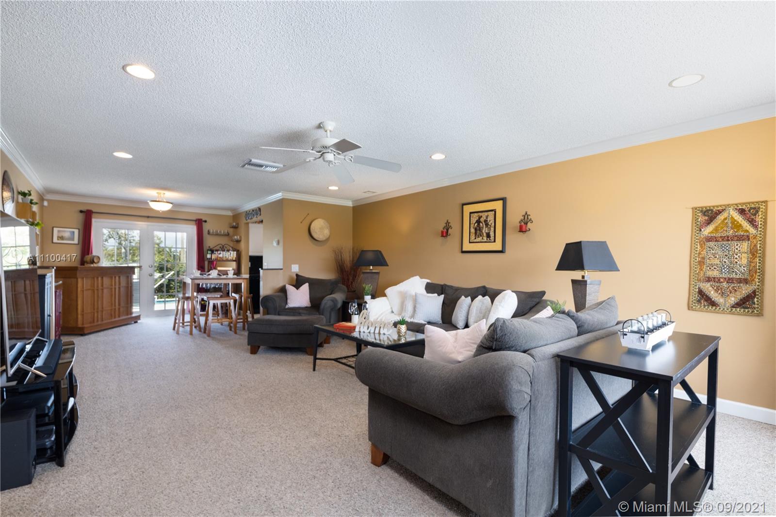 22565 Southwest 56th Avenue Boca Raton, FL 33433 - Photo 14 of 35 a living room with furniture and a lamp