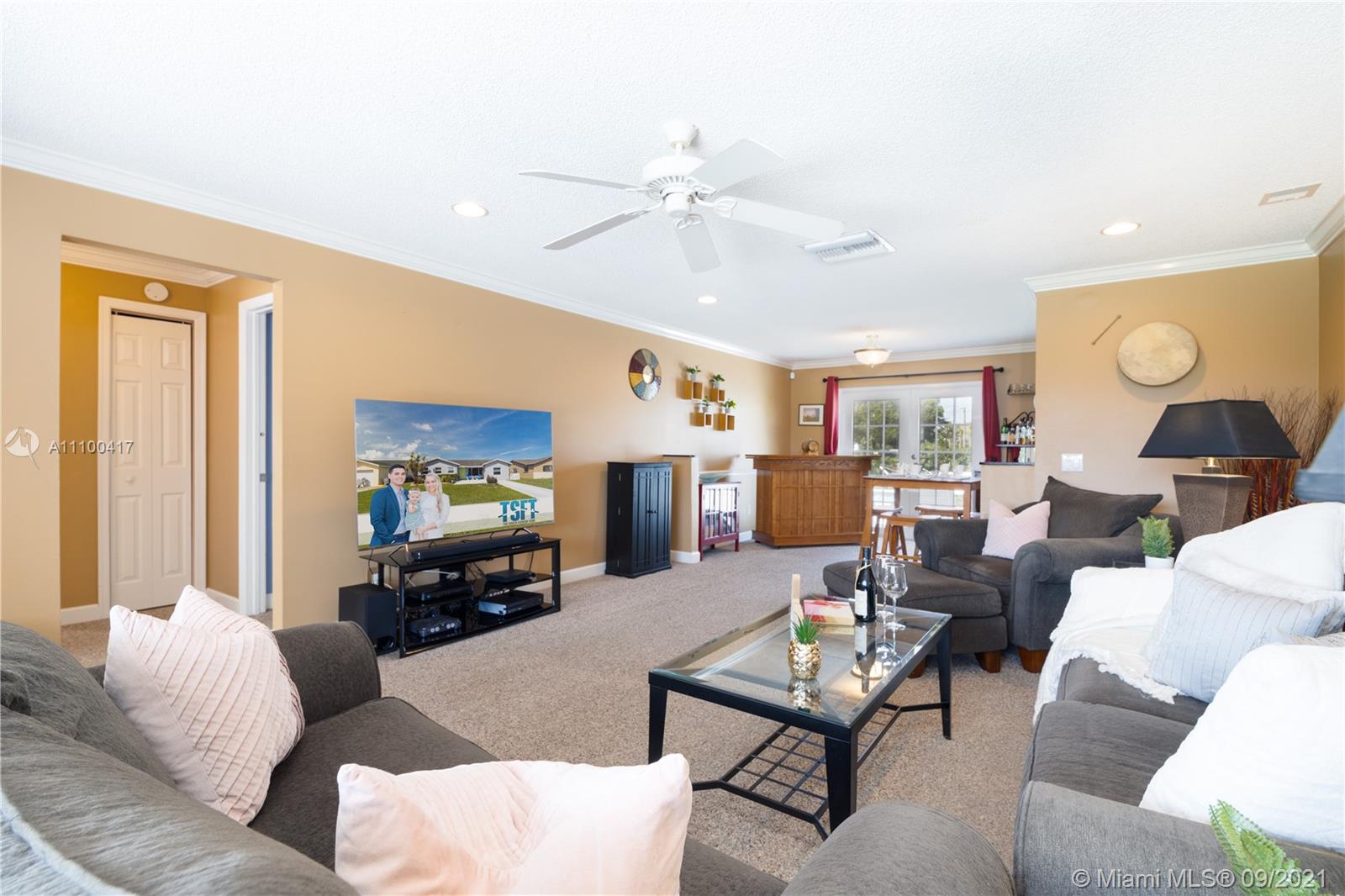 22565 Southwest 56th Avenue Boca Raton, FL 33433 - Photo 15 of 35 a living room with furniture and a flat screen tv