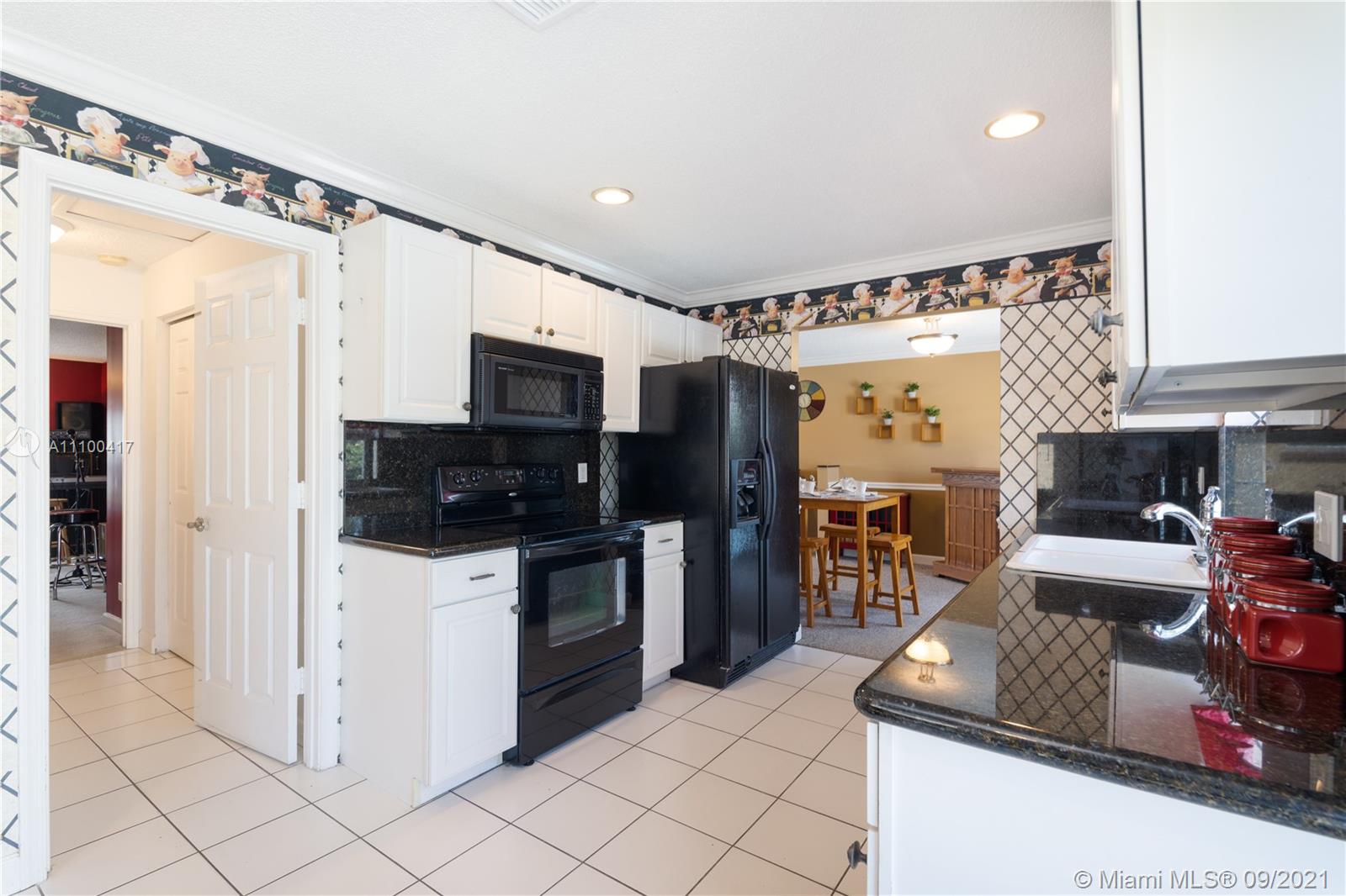 22565 Southwest 56th Avenue Boca Raton, FL 33433 - Photo 18 of 35 a kitchen with stainless steel appliances granite countertop a refrigerator and a sink