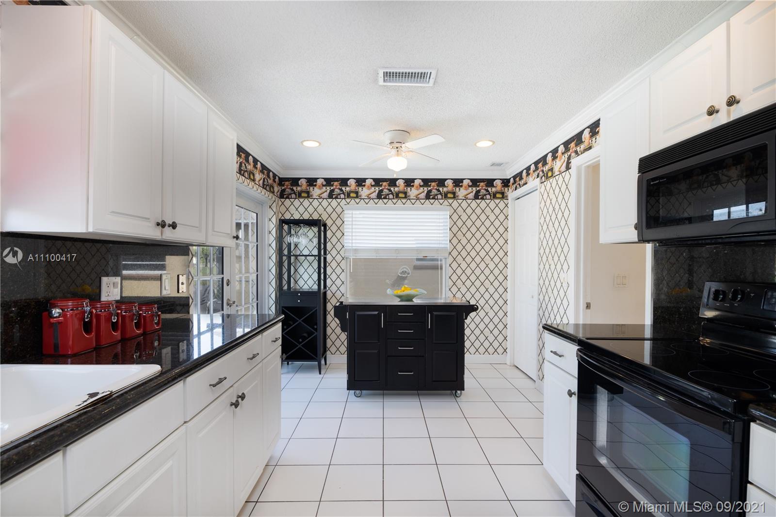 22565 Southwest 56th Avenue Boca Raton, FL 33433 - Photo 19 of 35 a kitchen with a sink and cabinets