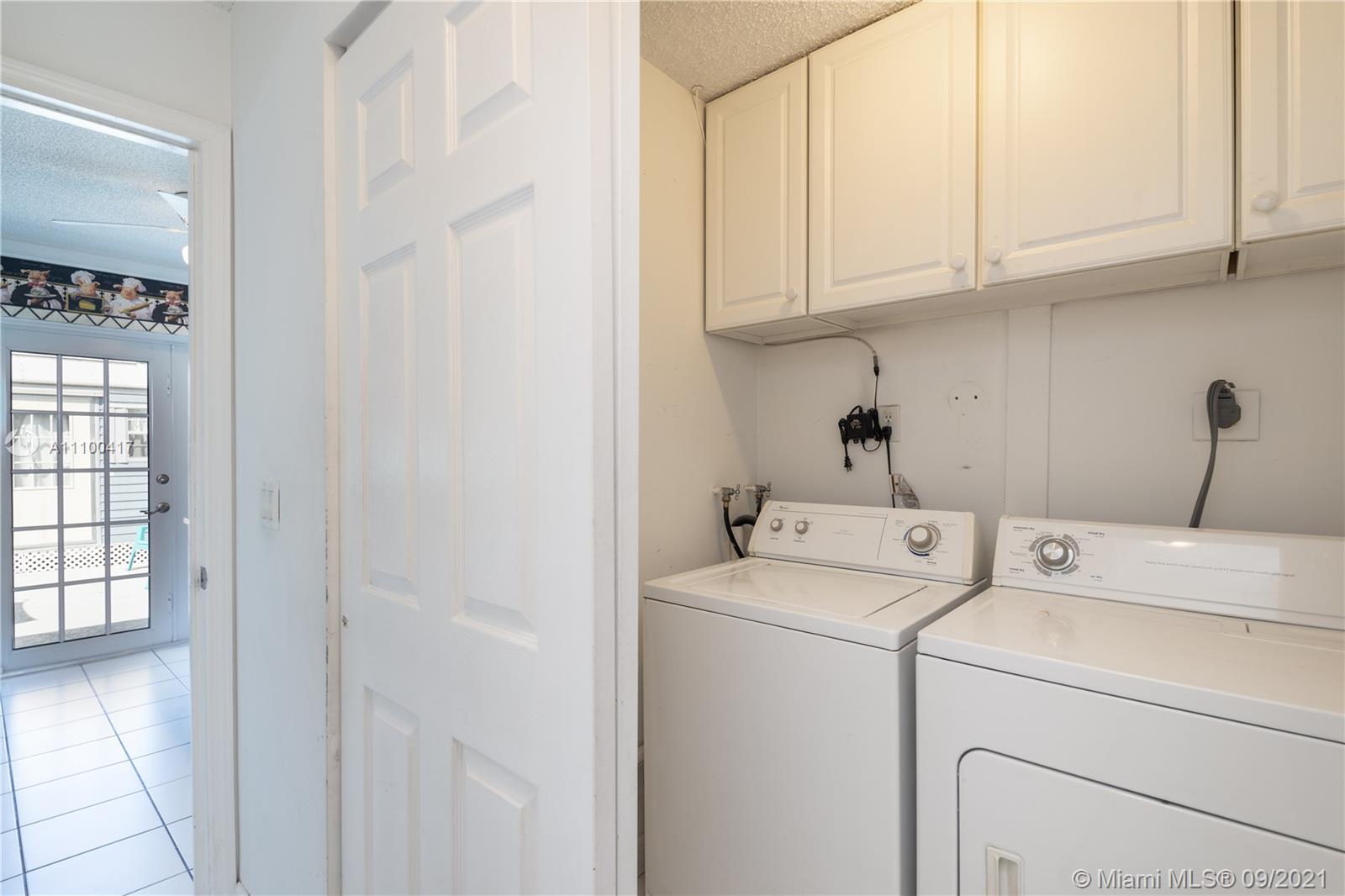 22565 Southwest 56th Avenue Boca Raton, FL 33433 - Photo 20 of 35 a view of storage and utility room with washer and dryer
