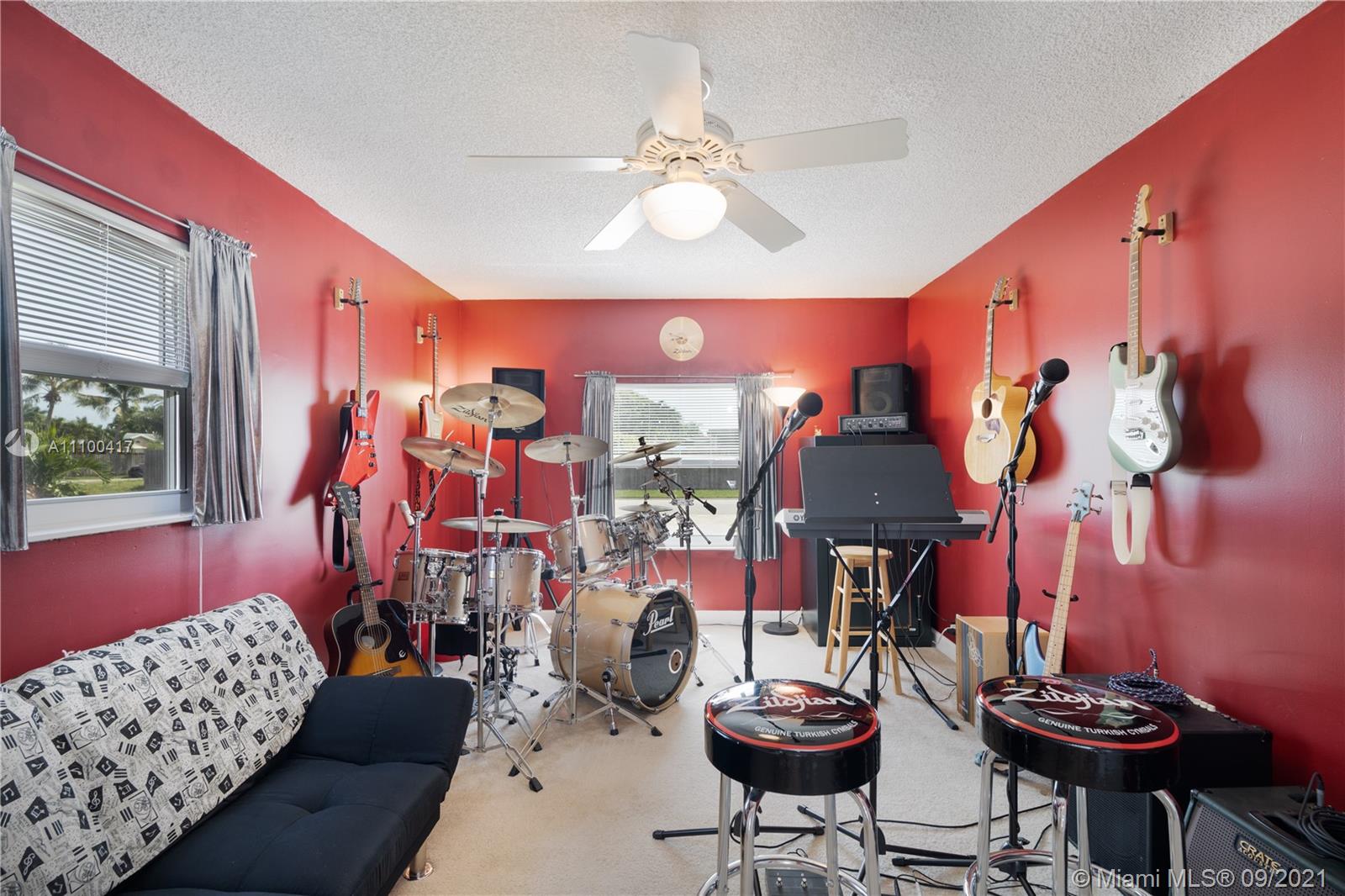 22565 Southwest 56th Avenue Boca Raton, FL 33433 - Photo 21 of 35 a living room filled with furniture and a chandelier