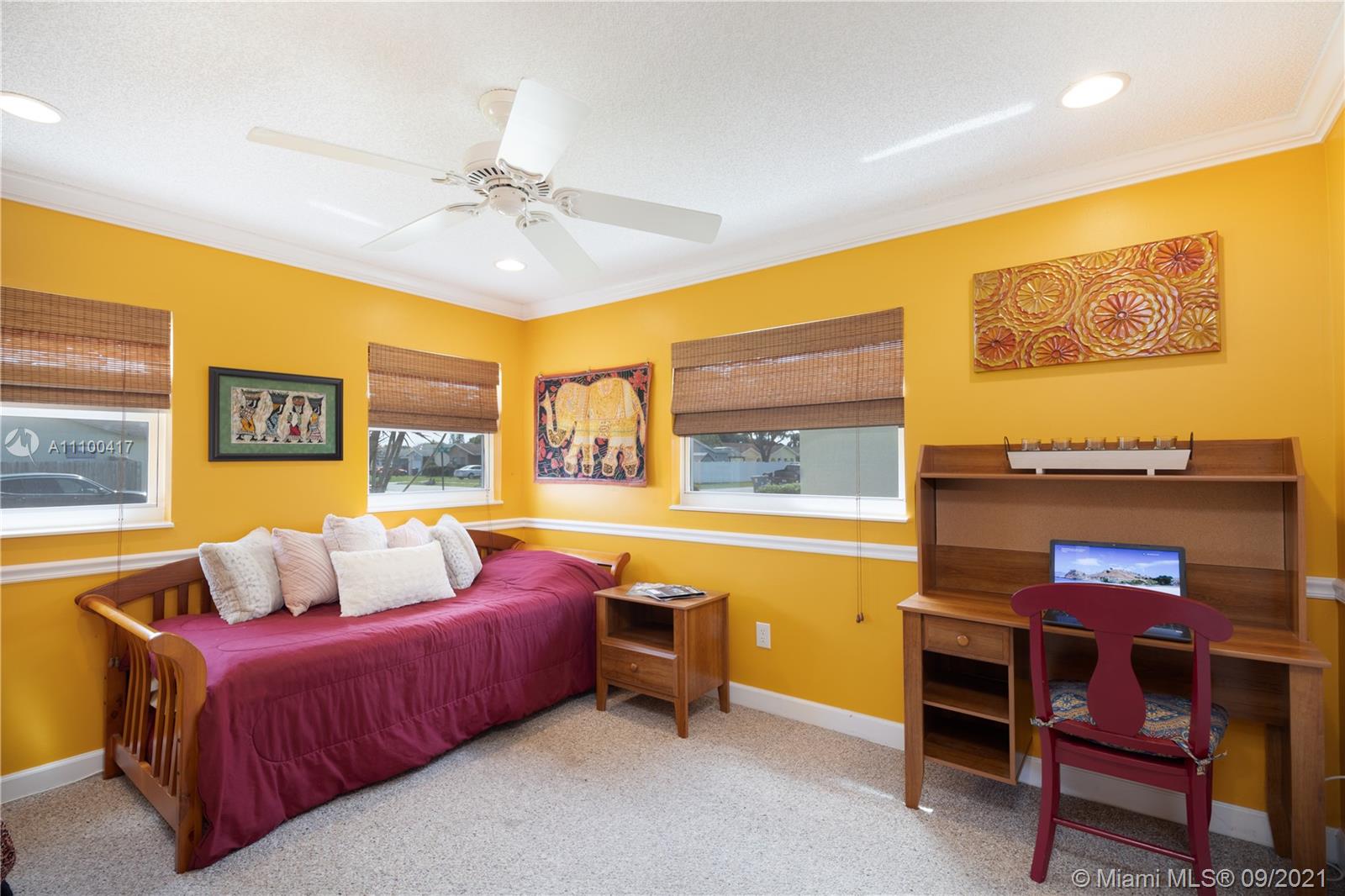 22565 Southwest 56th Avenue Boca Raton, FL 33433 - Photo 23 of 35 a bedroom with a bed and a table
