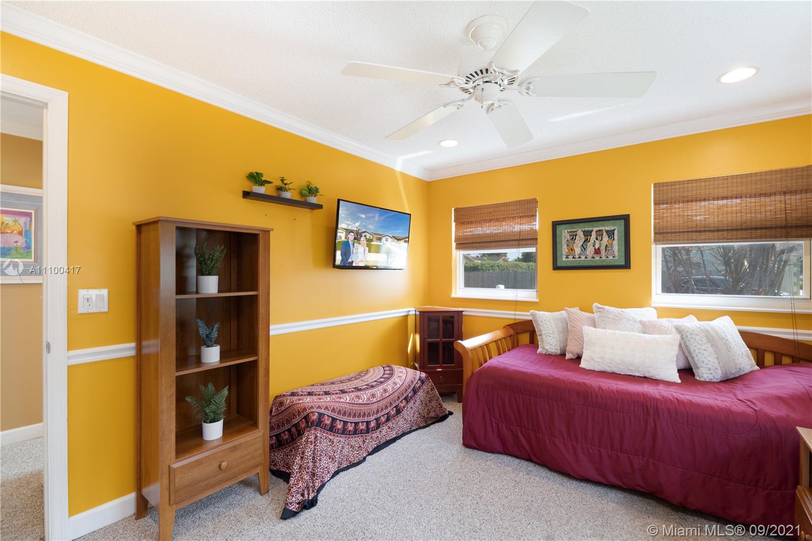 22565 Southwest 56th Avenue Boca Raton, FL 33433 - Photo 24 of 35 a bedroom with a bed and a chandelier