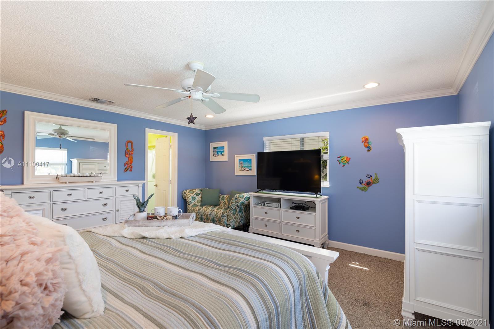 22565 Southwest 56th Avenue Boca Raton, FL 33433 - Photo 26 of 35 a bedroom with bed tv and window