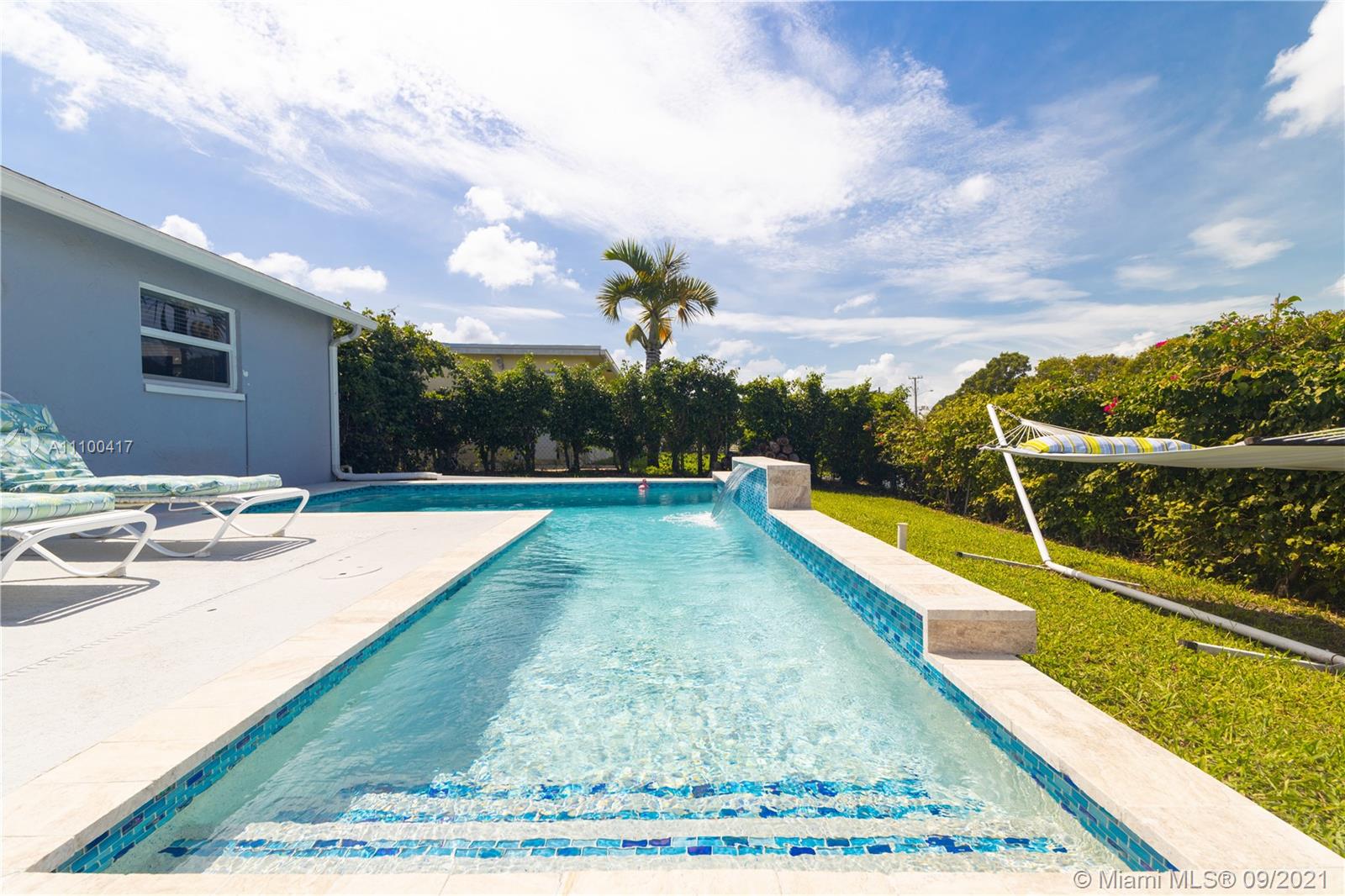 22565 Southwest 56th Avenue Boca Raton, FL 33433 - Photo 30 of 35 a view of a swimming pool with a lounge chairs