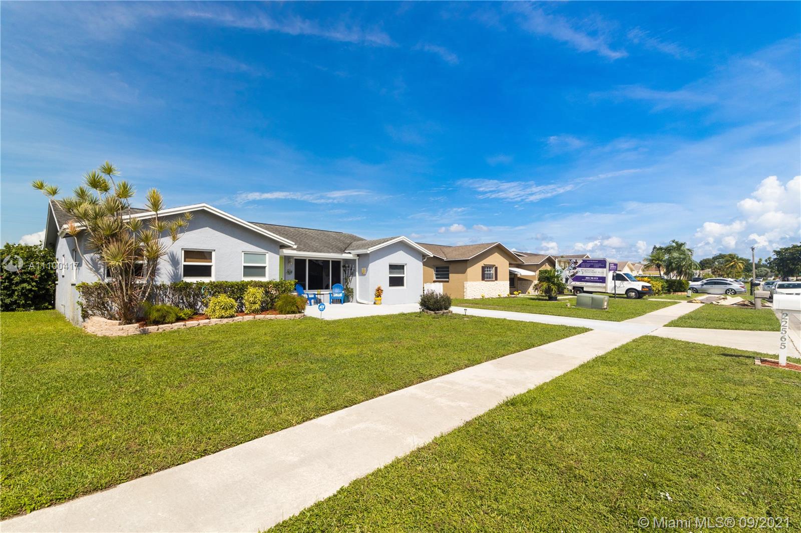 22565 Southwest 56th Avenue Boca Raton, FL 33433 - Photo 4 of 35 a front view of a house with a garden and yard