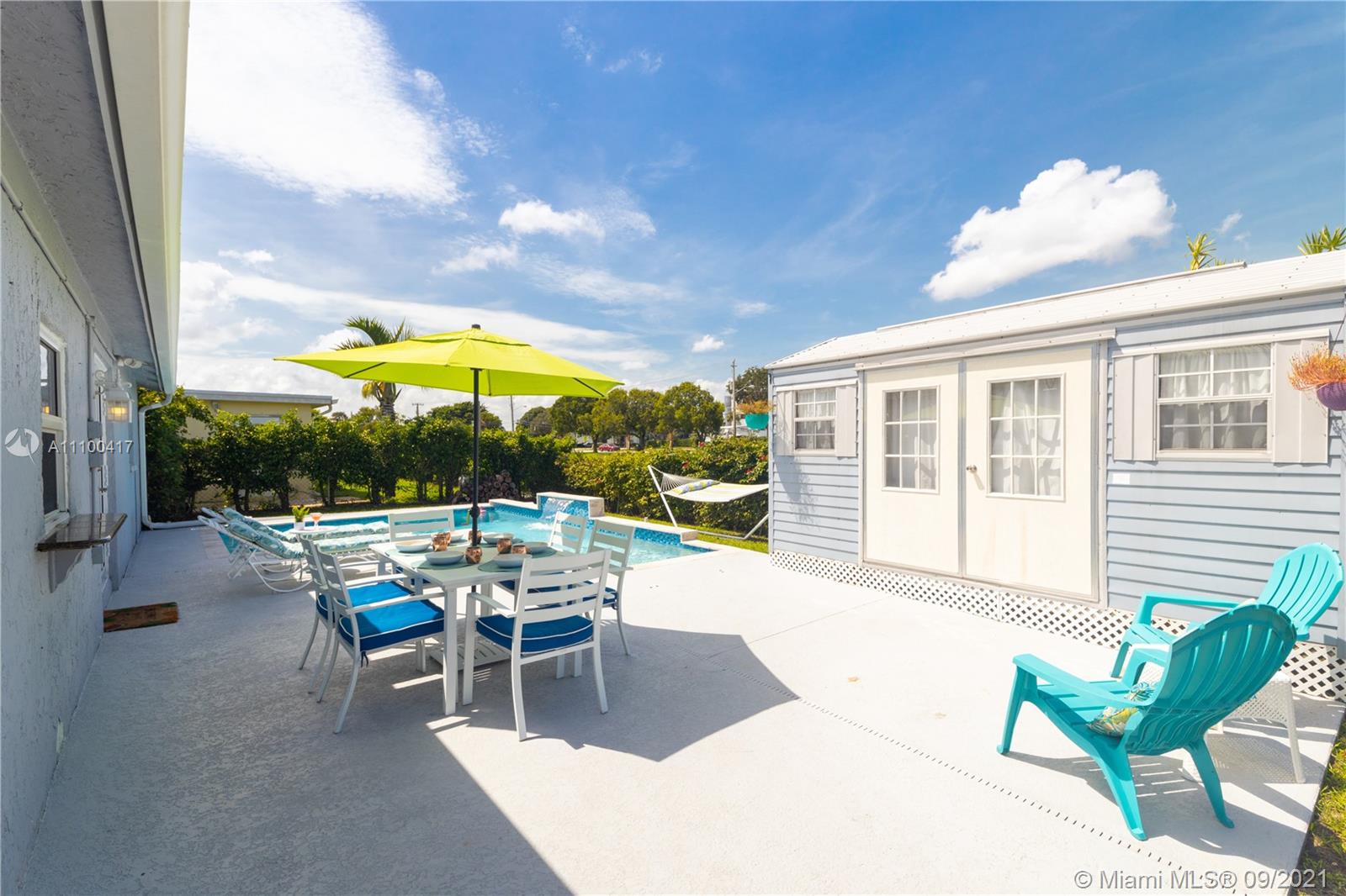 22565 Southwest 56th Avenue Boca Raton, FL 33433 - Photo 32 of 35 a building outdoor space with patio furniture and potted plants