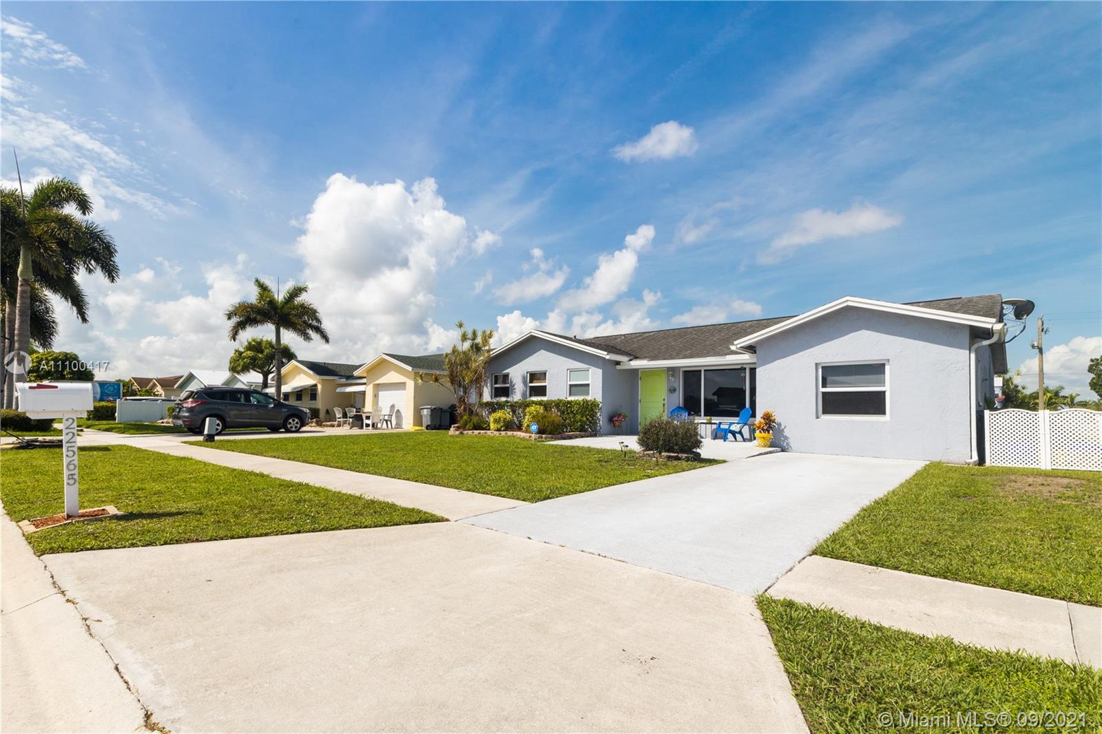 22565 Southwest 56th Avenue Boca Raton, FL 33433 - Photo 6 of 35 a front view of a house with garden