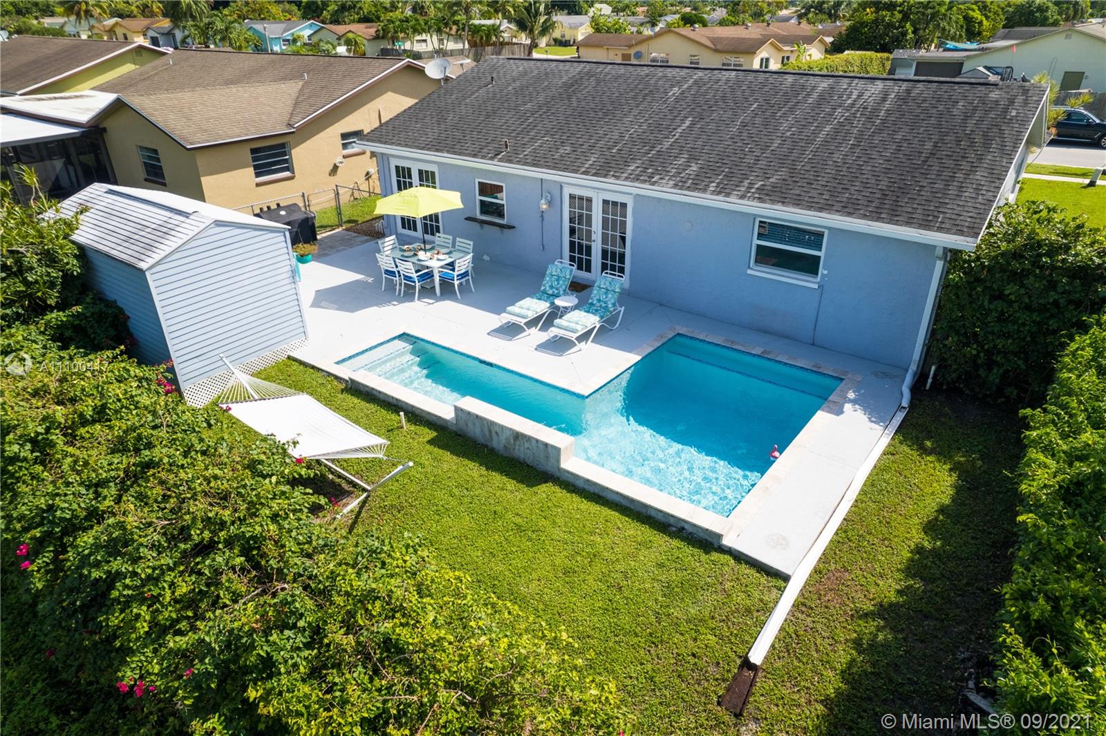 22565 Southwest 56th Avenue Boca Raton, FL 33433 - Photo 9 of 35 a view of a house with pool and chairs