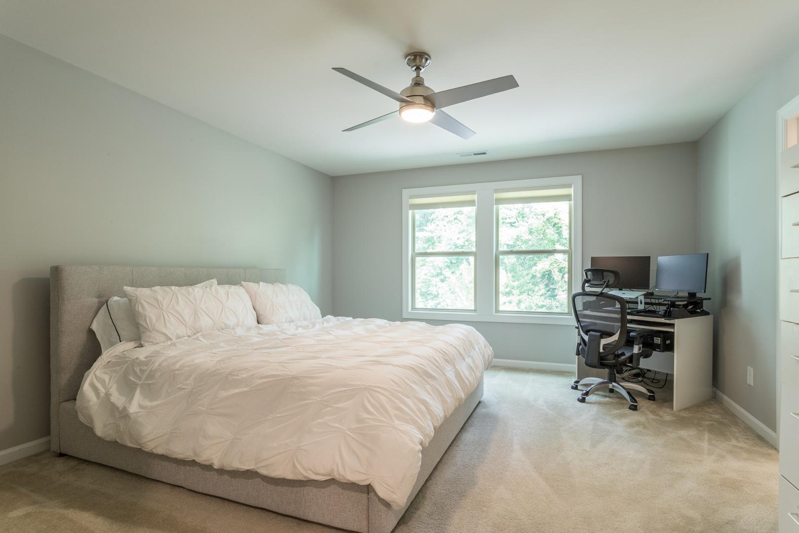 1015 Catch Fly Lane Durham, NC 27713 - Photo 8 of 26 a bedroom with a bed and a desk