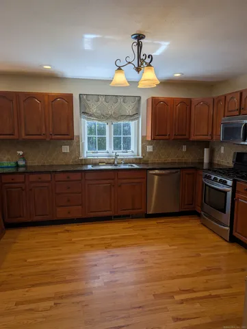 a kitchen with stainless steel appliances granite countertop a sink and cabinets