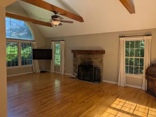 a view of a livingroom with a fireplace and window