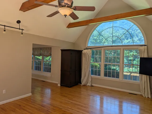 wooden floor in an empty room with a window