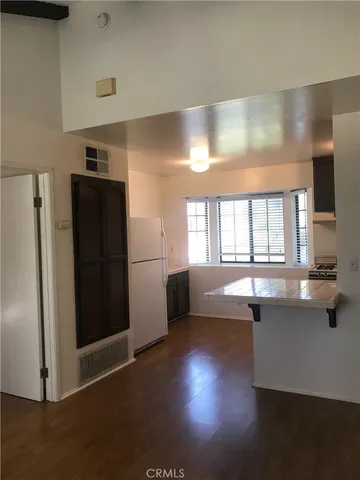 a kitchen with granite countertop a refrigerator and a sink