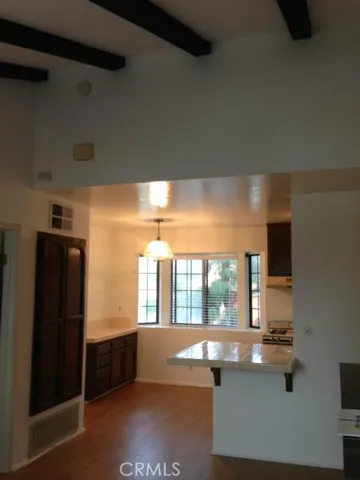 a room with wooden floor and large window