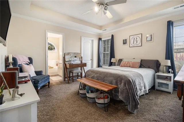 a spacious bedroom with a bed and a chair