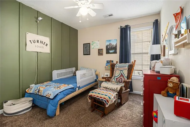 a living room with furniture and a baby crib