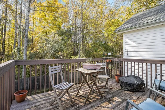 a view of a chairs and table on the roof deck