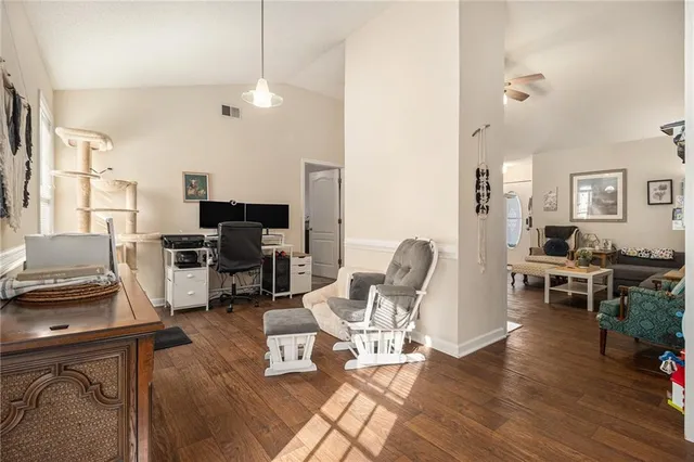 a living room with furniture flat screen tv and wooden floor
