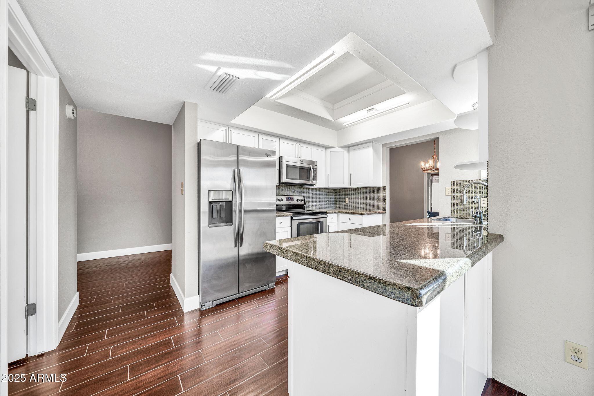 18548 East Parada Circle Rio Verde, AZ 85263 - Photo 11 of 35 a kitchen with stainless steel appliances granite countertop a refrigerator and a sink