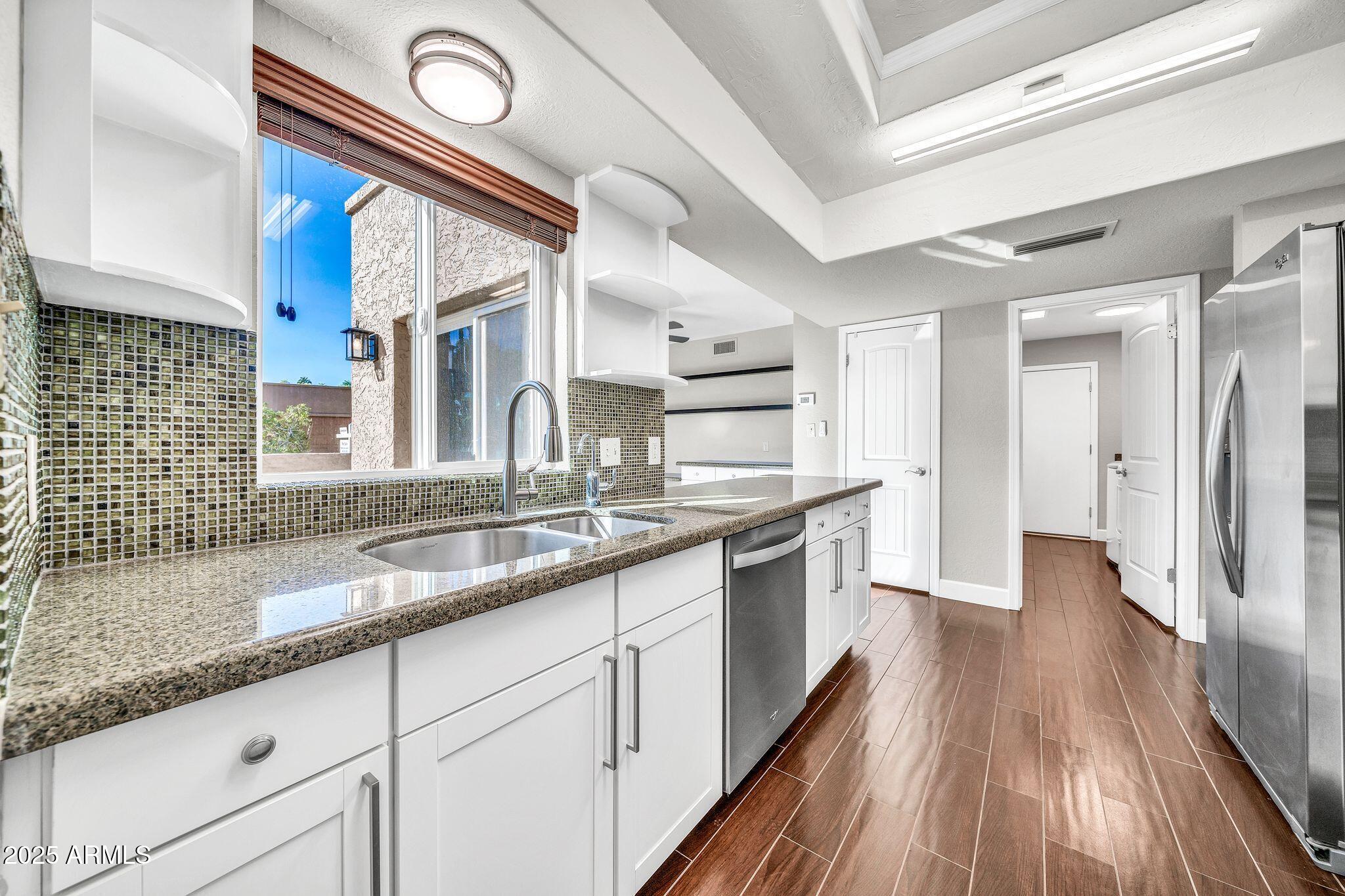 18548 East Parada Circle Rio Verde, AZ 85263 - Photo 12 of 35 a kitchen with granite countertop a sink and cabinets