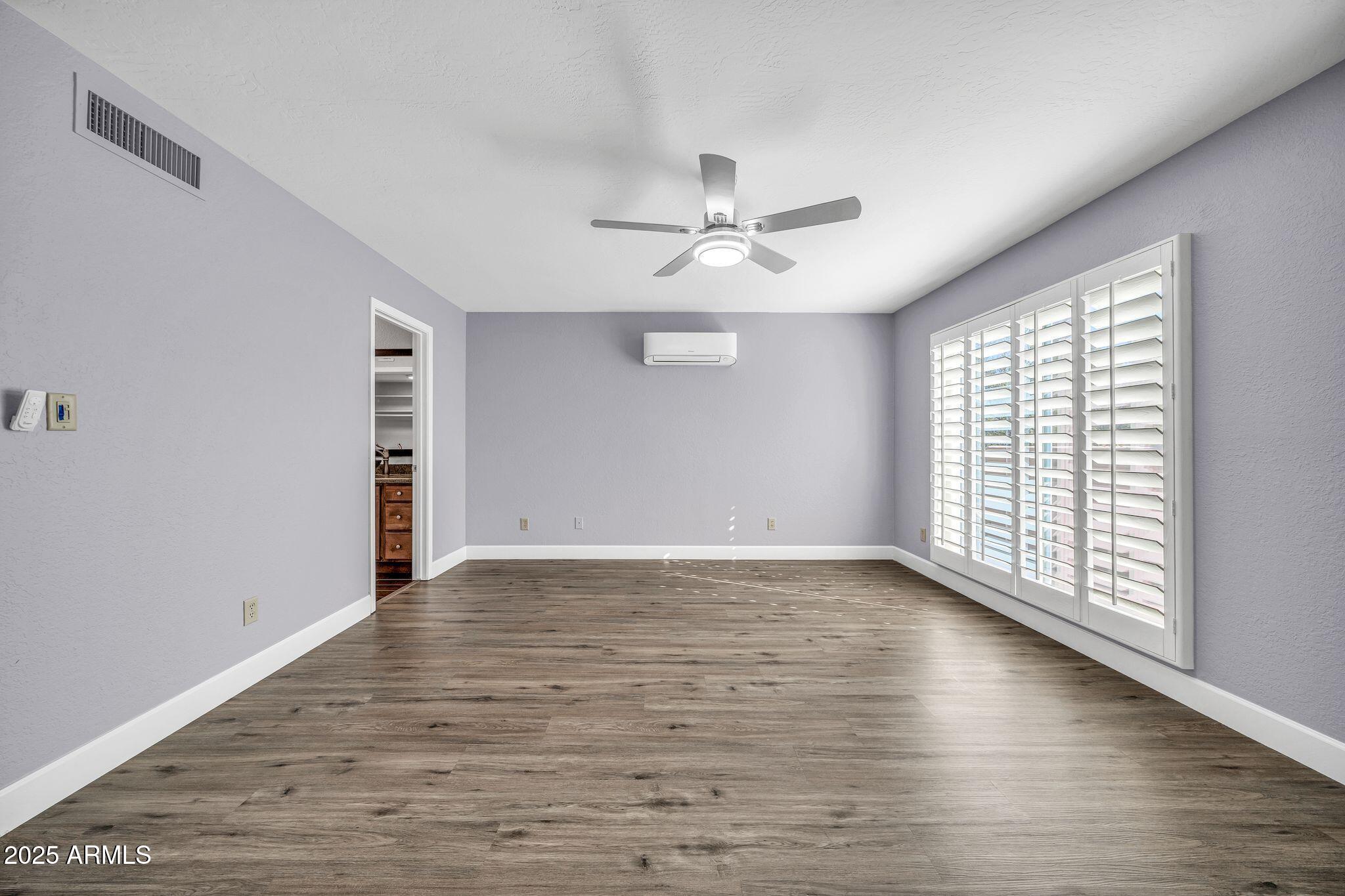 18548 East Parada Circle Rio Verde, AZ 85263 - Photo 21 of 35 a view of an empty room with a window and wooden floor