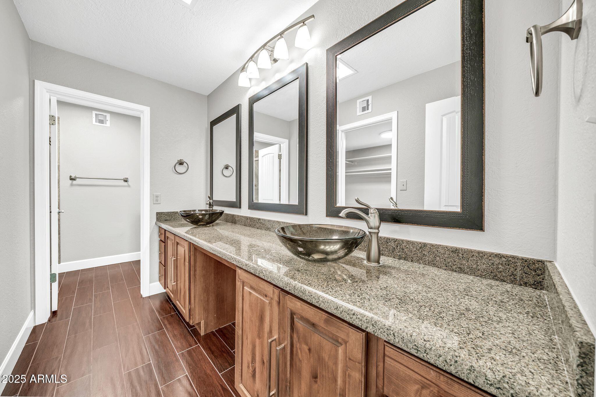 18548 East Parada Circle Rio Verde, AZ 85263 - Photo 24 of 35 a bathroom with a granite countertop sink and a mirror