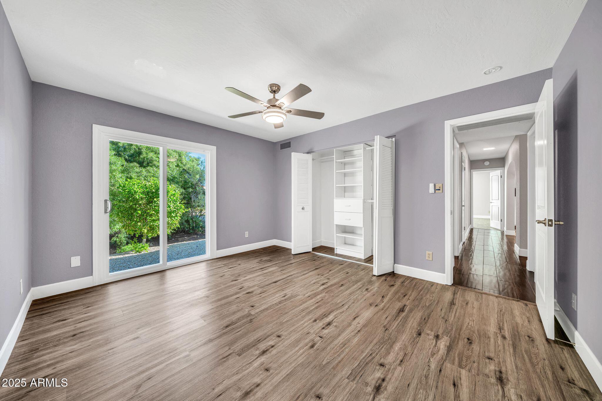 18548 East Parada Circle Rio Verde, AZ 85263 - Photo 28 of 35 a view of an empty room with wooden floor and a window