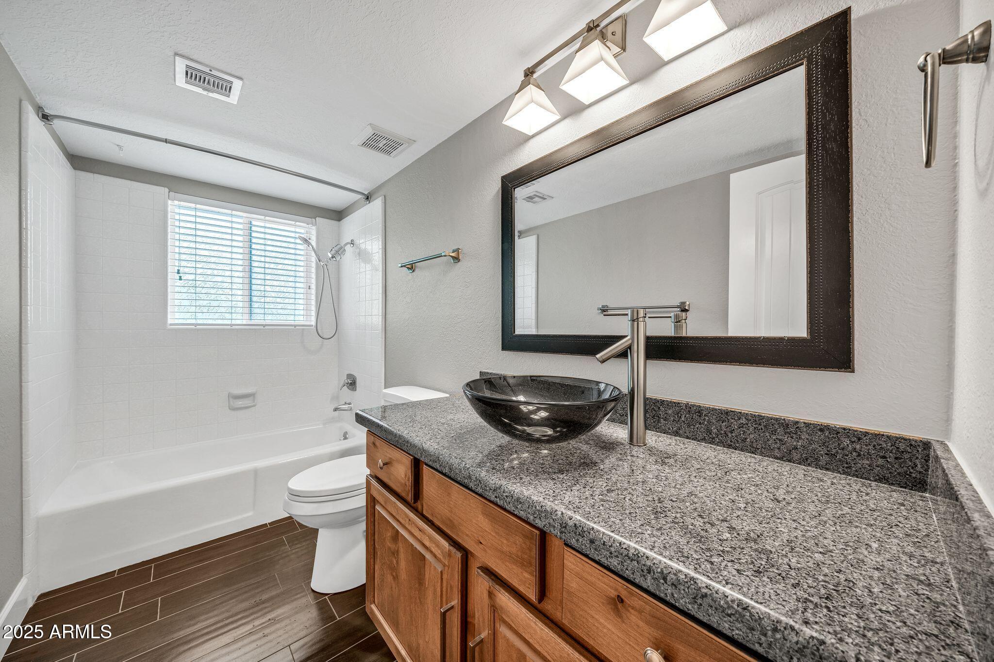 18548 East Parada Circle Rio Verde, AZ 85263 - Photo 30 of 35 a bathroom with a granite countertop tub a sink and a mirror
