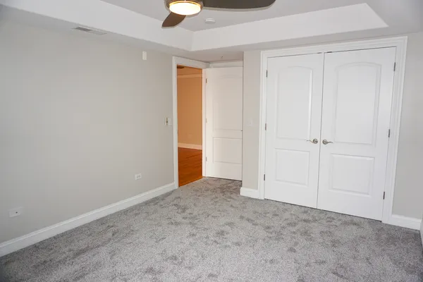 an empty room with a ceiling fan and a window
