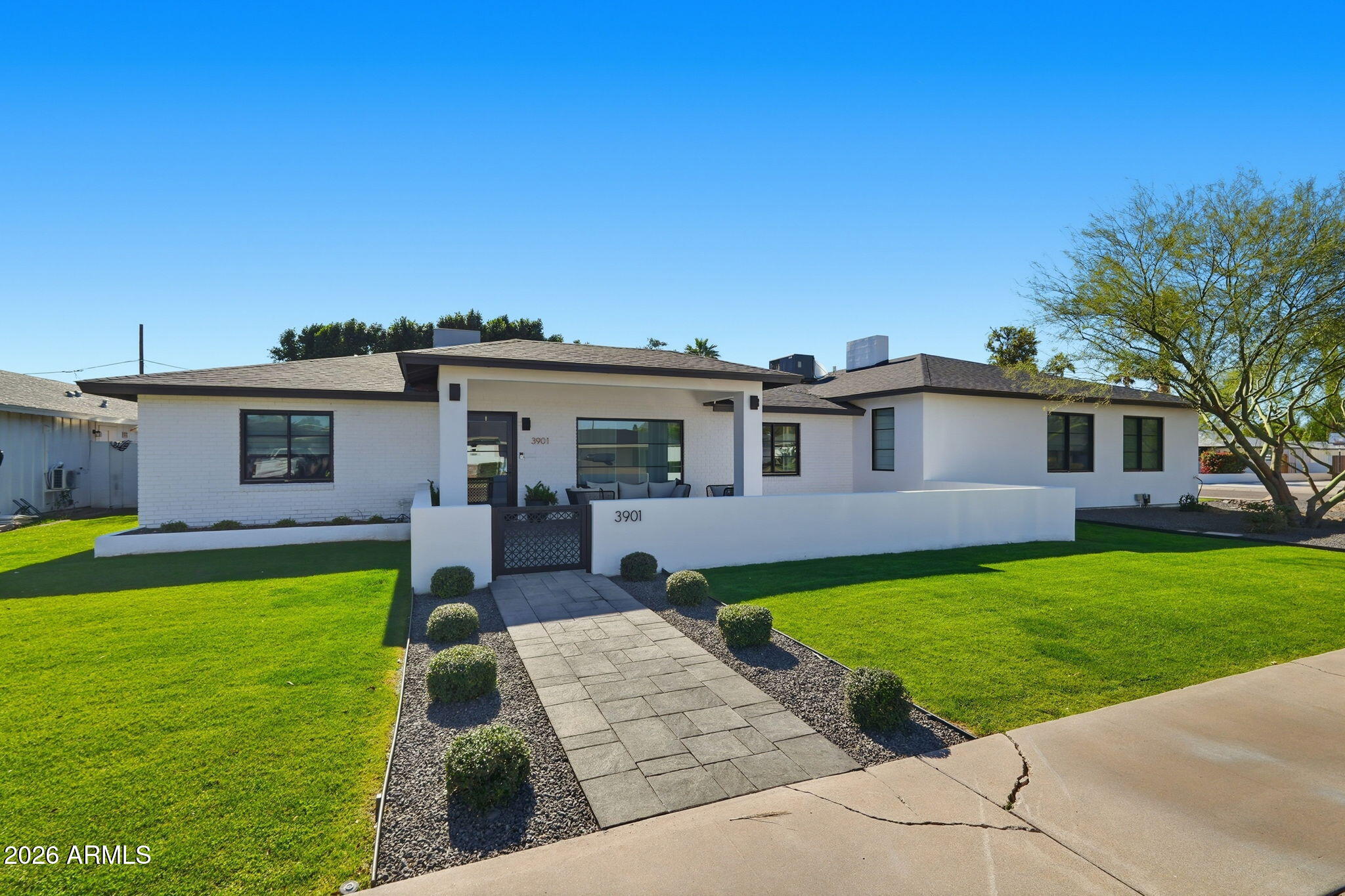 3901 East Weldon Avenue Phoenix, AZ 85018 - Photo 2 of 27 a front view of a house with garden and patio