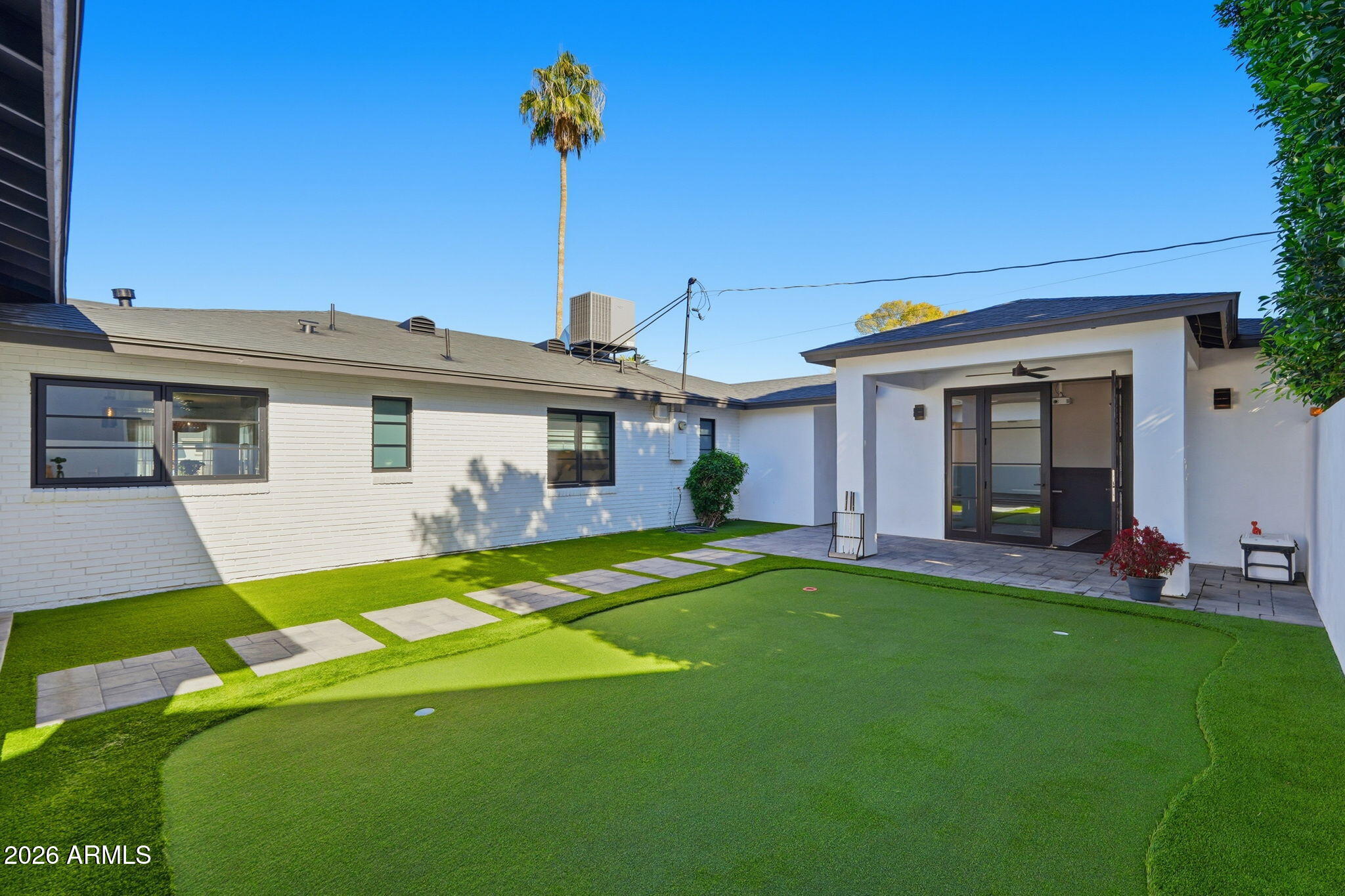 3901 East Weldon Avenue Phoenix, AZ 85018 - Photo 24 of 27 a front view of a house with a garden and yard