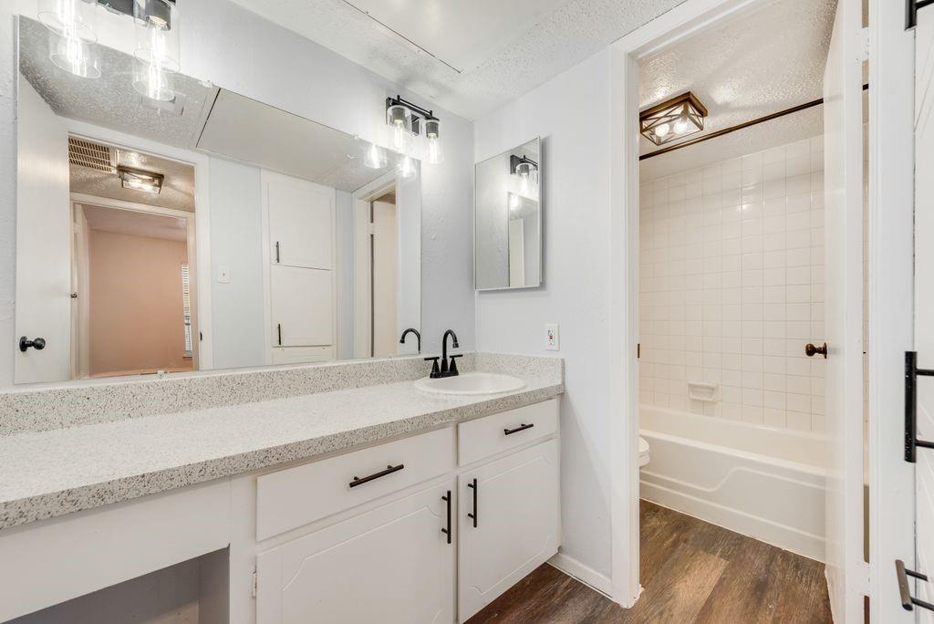 5514 Boca Raton Boulevard, Unit 438 Fort Worth, TX 76112 - Photo 13 of 25 a bathroom with a tub shower vanity and a sink